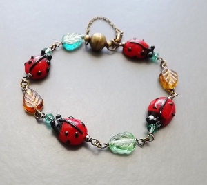 Handmade nature ladybird lampwork glass bracelet stylish bronze colour magnetic clasp, with a safety chain for added security