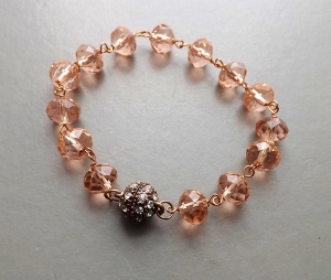 A fancy diamante studded magnetic copper clasp fitted to a glass bead bracelet.