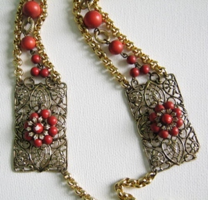 close up detail of the previous faux coral necklace showing beaded detail and filigree metal work