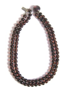 image shows a vintage West Germany necklace, amde up of two simple strands of brown round glass beads