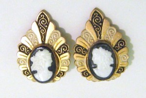 photo shows a pair of black and white cameo glass earrings set into a large black and gold faux enamel fancy frame