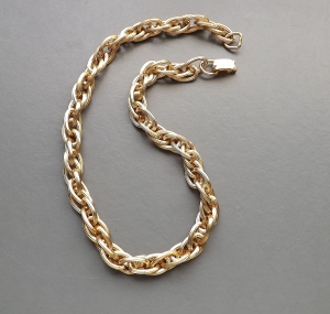 Image shows a chunky twisted link gold tone chain, made from plated aluminium metal and signed W Germany
